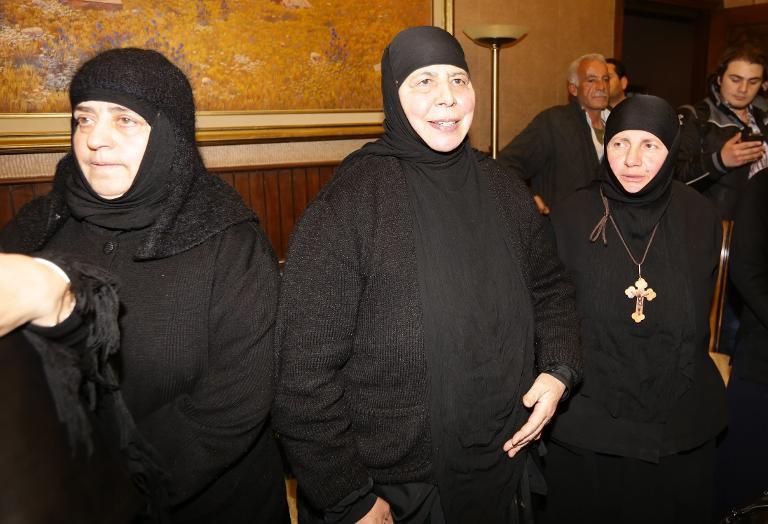 kidnapped nuns arrive at jdeidet yabus on the syrian side of the border with lebanon following their release on march 10 2014 photo afp