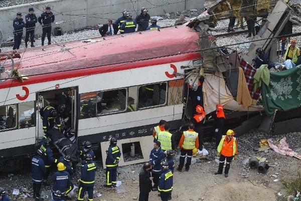 rescue workers evacuate the body of a victim following a terror bombing on a train at the atocha railway station in madrid on march 11 2004 photo afp