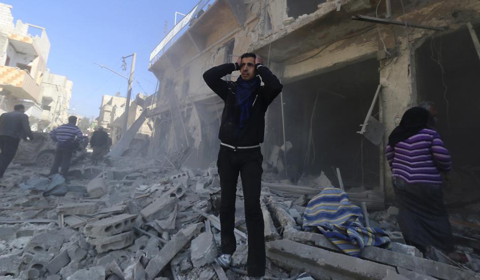 a man reacts at a site hit by what activists said were explosive barrels thrown by forces loyal to syria 039 s president bashar al assad in the al haidariya neighbourhood of aleppo february 12 2014 photo reuters