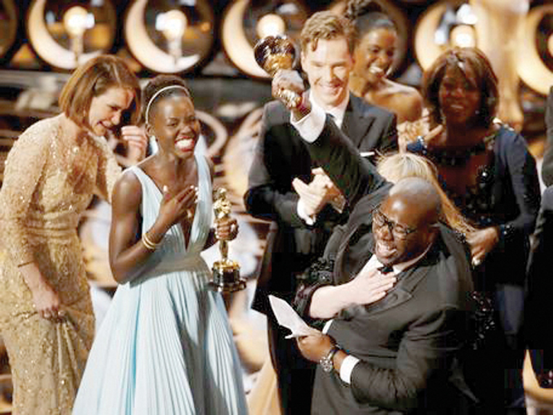 director and producer steve mcqueen celebrates after accepting the oscar for best picture for 12 years a slave with lupita nyong o and benedict cumberbatch at the academy awards photo file