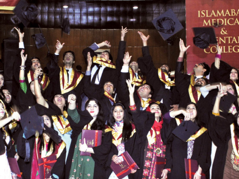 graduates throwing their caps in the air after receiving their degrees on tuesday photo express