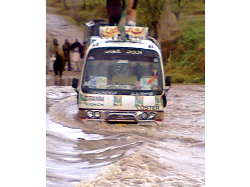 a bus trapped on a flooded road in bhimber photo inp online