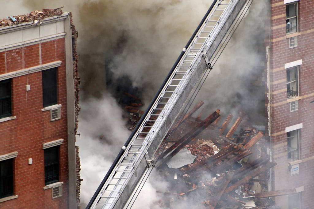 smoke rises from a five alarm fire and building collapse at 1646 park ave in the harlem neighborhood of manhattan march 12 2014 in new york city photo afp