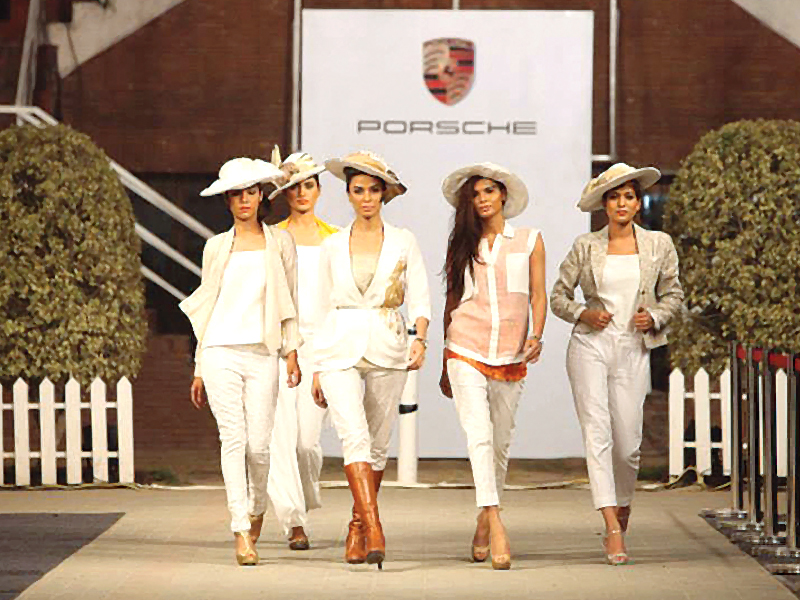 the porche team posing for the camera after putting up a successful fashion savvy polo event photo publicity