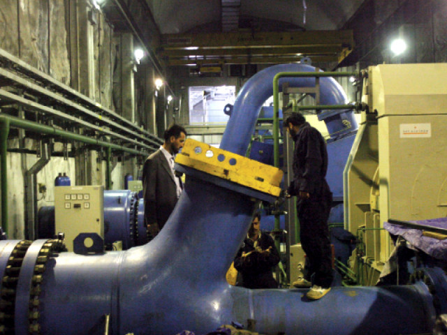 two technicians at a more sophisticated power plant photo afp two technicians at a more sophisticated power plant photo afp
