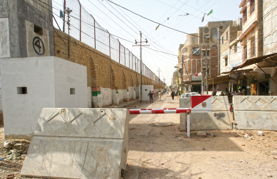 with barriers and concrete blocks jail authorities have restricted access to ghousia colony located next to the karachi prison on university road the barrier is locked and only opened for law enforcers and prison vans photos athar khan express