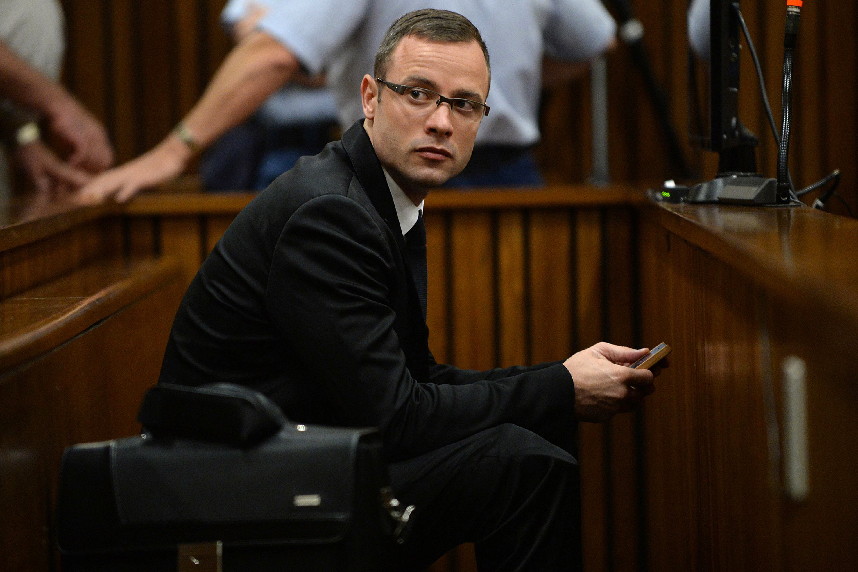 south african paralympic athlete oscar pistorius sits in the dock on day 10 of his murder trial at the north gauteng high court in pretoria on march 14 2014 photo afp photo