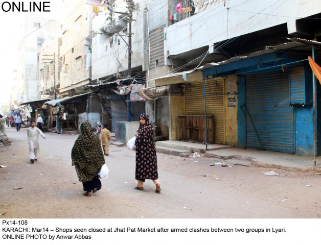 people walk past a closed jhat pat market in lyari on friday photo online people walk past a closed jhat pat market in lyari on friday photo online