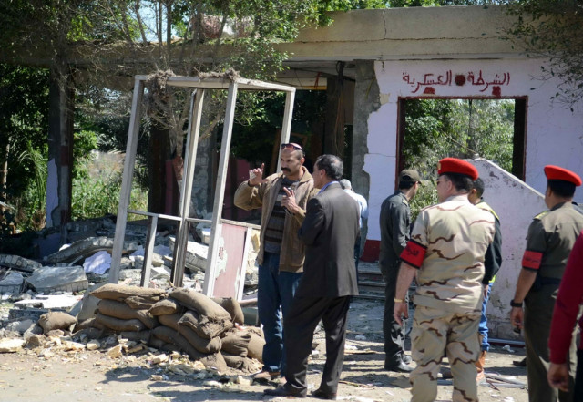 egyptian soldiers and officials inspect the sight where gunmen killed six soldiers at a cairo checkpoint on march 15 2014 photo afp egyptian soldiers and officials inspect the sight where gunmen killed six soldiers at a cairo checkpoint on march 15 2014 photo afp