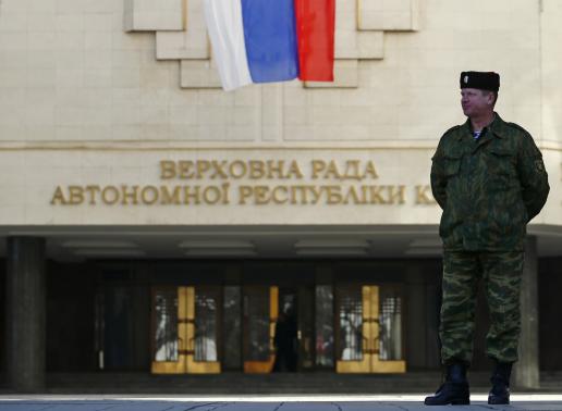 a member of a crimean self defence unit guards the crimean parliament building on the eve of a referendum in simferopol march 15 2014 photo reuters