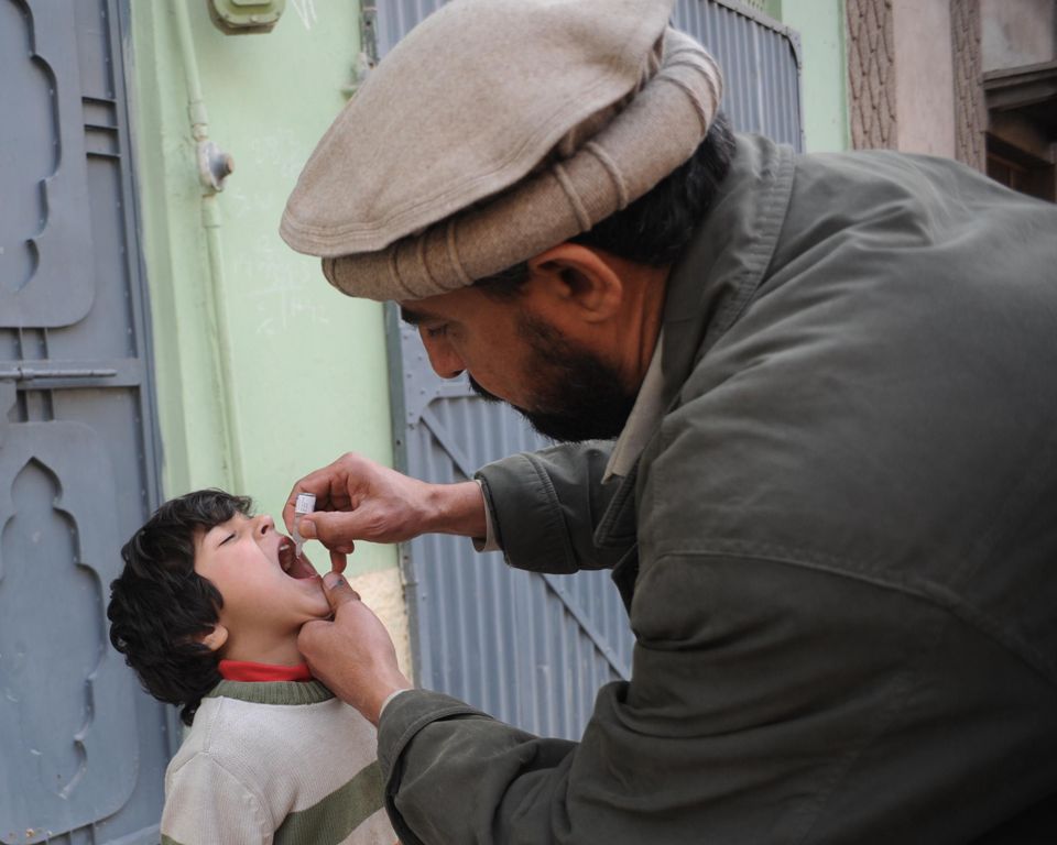 a health worker administers a polio vaccination to a child during a polio immunisation campaign in peshawar photo afp