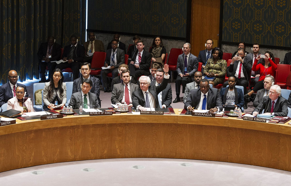 russian ambassador to the un vitaly churkin c vetoes a resolution on ukraine during a un security council emergency meeting at united nations headquarters in new york on march 15 2014 photo afp