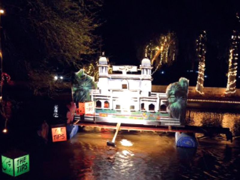 a model of zila council building floats in the canal as part of the festival photo express