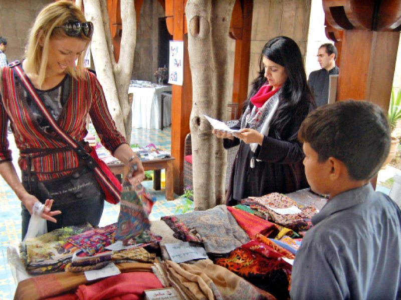 shoppers at the bazaar looking through the many interesting pieces photo muhammad javaid express