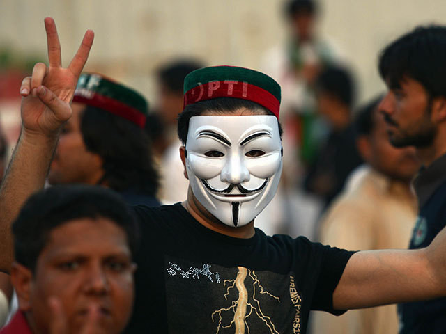 a pti supporter flashes victory sign during a protest march against the government photo afp a pti supporter flashes victory sign during a protest march against the government photo afp