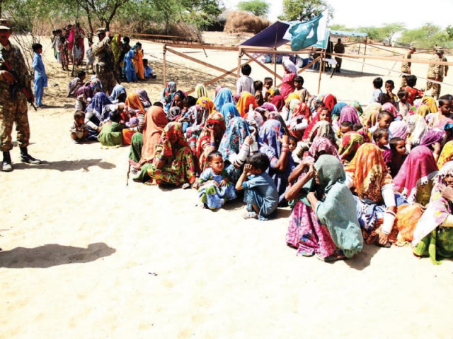 women wait for their turn to get relief goods at an army camp in tharparkar photo online women wait for their turn to get relief goods at an army camp in tharparkar photo online