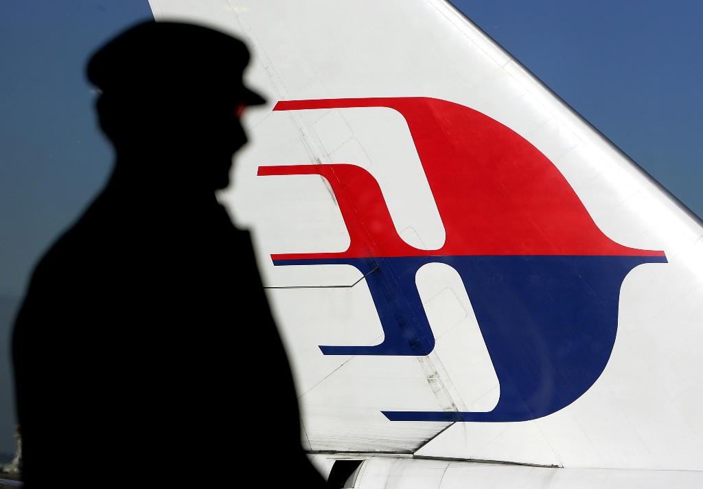 file photo of a man silhouetted against a malaysian airlines plane tail photo afp file
