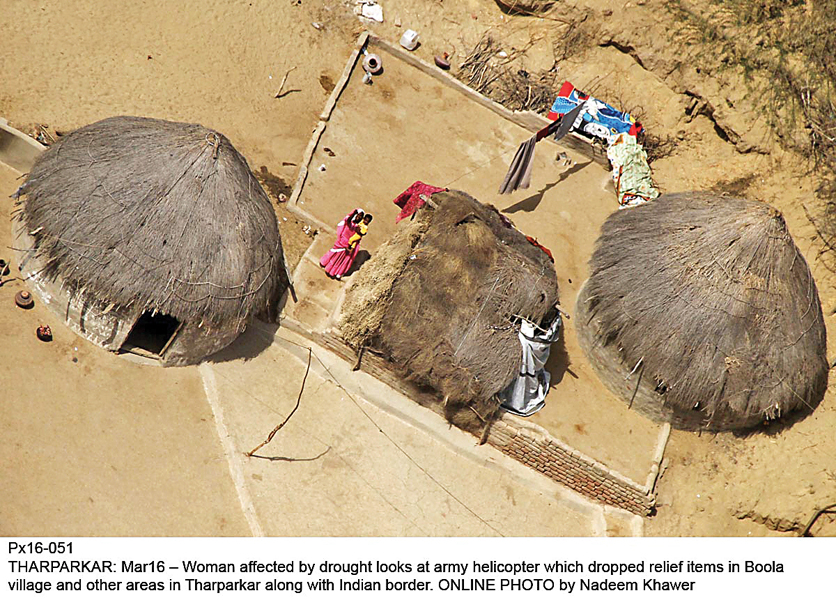 women living in drought hit tharparkar watch as the army helicopter drops relief items in boola village along the indian border photo online