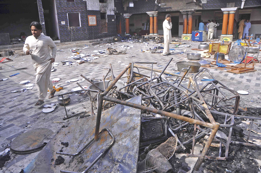 community members inspect the damage at the hindu temple in larkana photo reuters