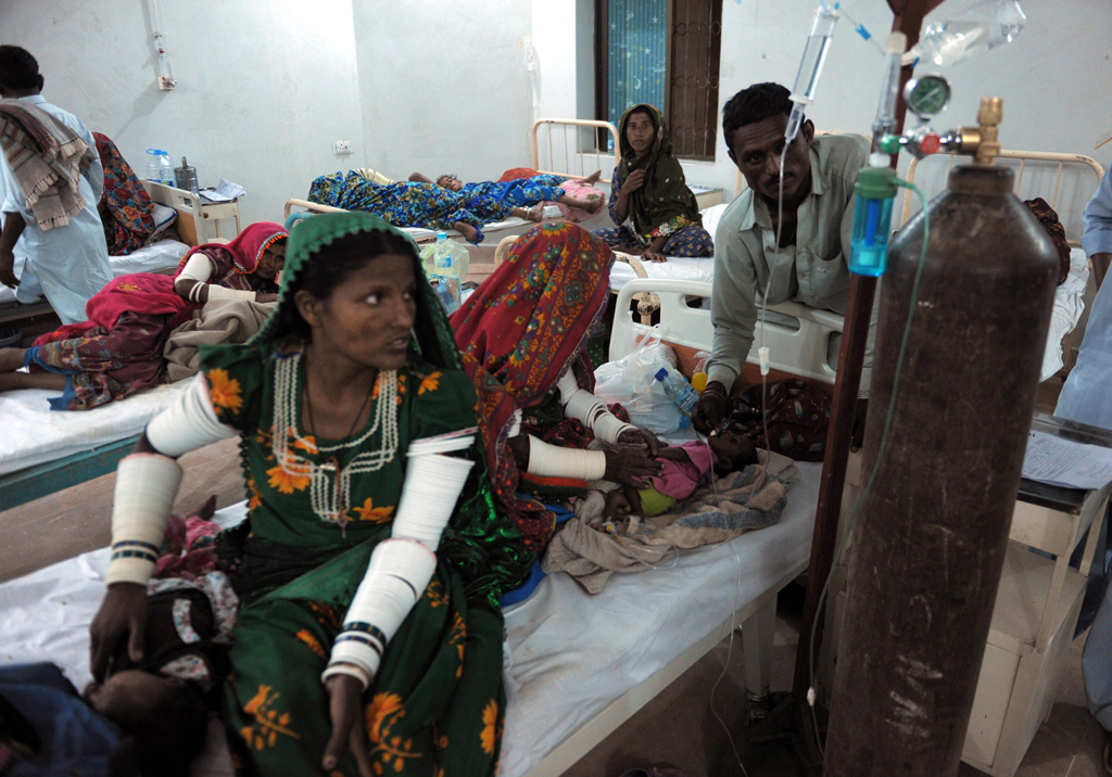 this photo taken on march 10 2014 shows villager families tending to their sick children affected by a famine at a hospital in mithi the capital of the tharparkar district around 300 kilometres from karachi photo afp