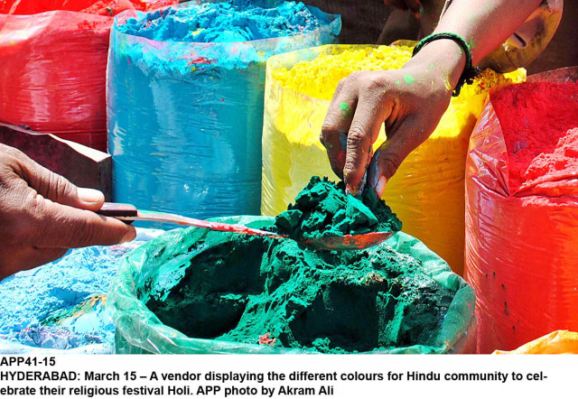 people celebrating holi throw coloured powder and coloured water at each other during the hindu festival of holi photo app file