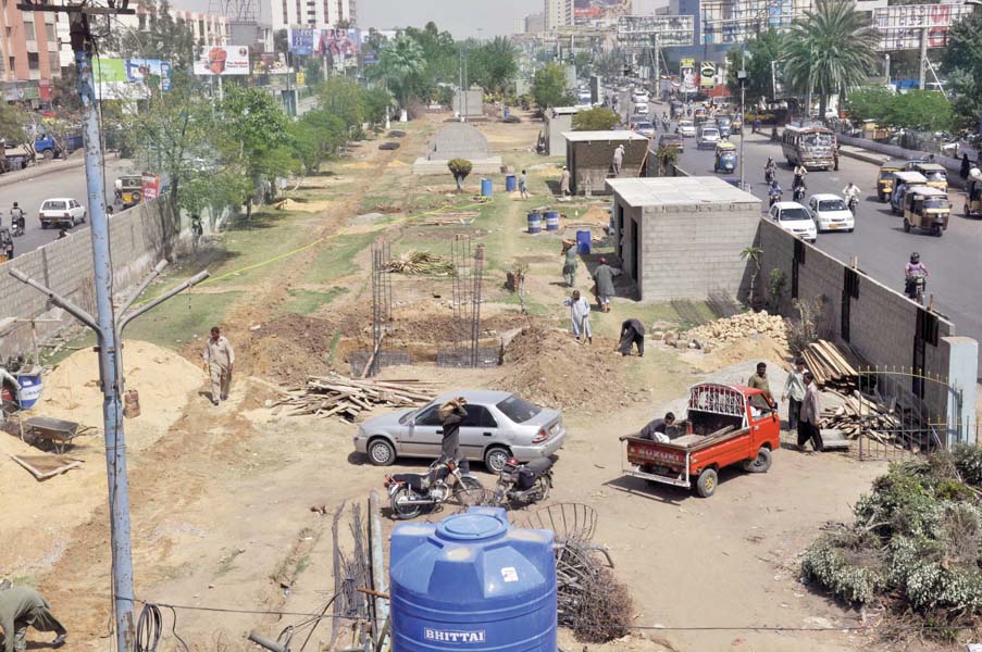 brick walls have been built on both sides of the median on hyderi road for a project by an mna a wind room will be built here to create awareness on alternative energy sources photo athar khan express