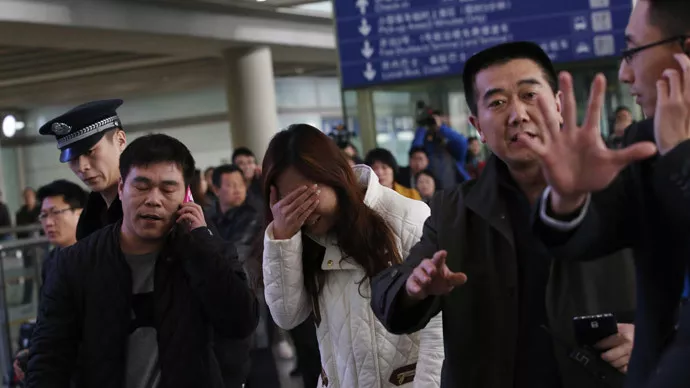 a relative of a passenger onboard malaysia airlines flight mh370 covers her face as she cries at the beijing capital international airport on march 8 2014 photo reuters a relative of a passenger onboard malaysia airlines flight mh370 covers her face as she cries at the beijing capital international airport on march 8 2014 photo reuters