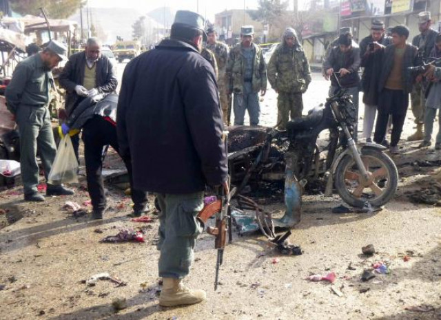 an afghan police officer stands at the site of a suicide blast in faryab northern afghanistan march 18 2014 photo reuters an afghan police officer stands at the site of a suicide blast in faryab northern afghanistan march 18 2014 photo reuters