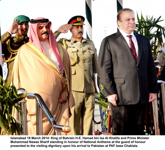 prime minister nawaz sharif r stands alongside the king of bahrain hamad bin isa al khalifa after the latter arrived in pakistan on tuesday photo pid