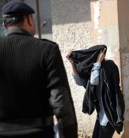 khadija shah r walks past a pakistani policeman after a court hearing in rawalpindi on march 18 photo afp khadija shah r walks past a pakistani policeman after a court hearing in rawalpindi on march 18 photo afp
