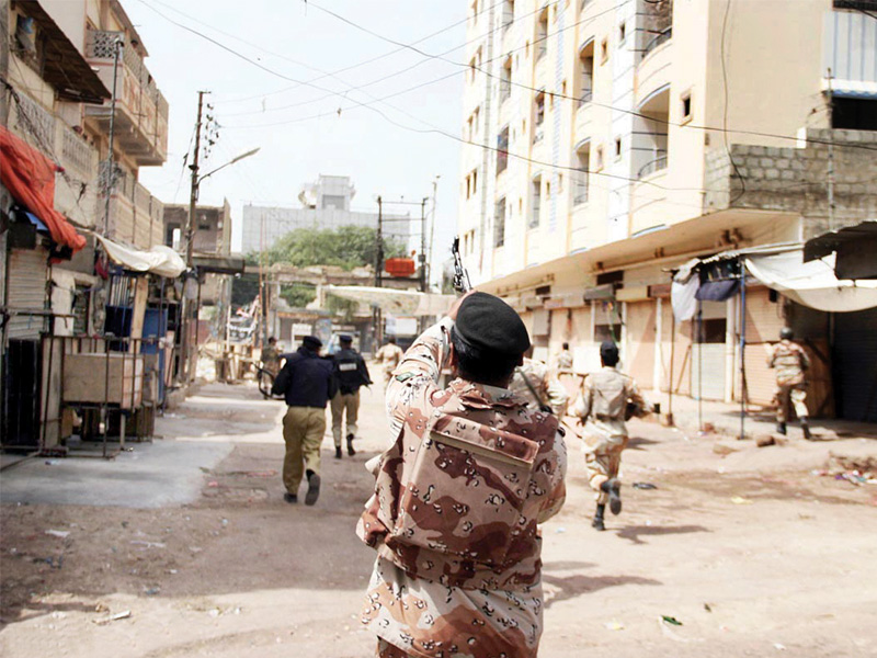 a ranger fires into the air as his comrades storm a position in lyari photo online file