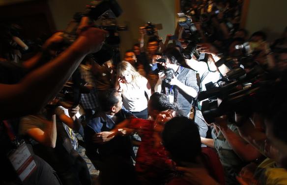 a chinese family member of a passenger onboard the missing malaysia airlines flight mh370 screams as she is being brought into a room outside the media conference area at a hotel in kuala lumpur international airport march 19 2014 photo reuters