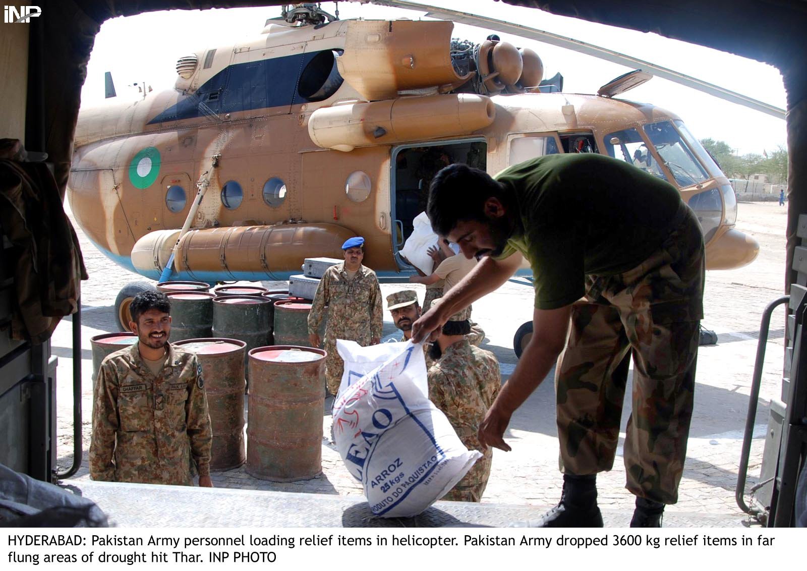 a soldier offloads relief goods from a truck before it is loaded onto a helicopter for distribution in thar photo inp