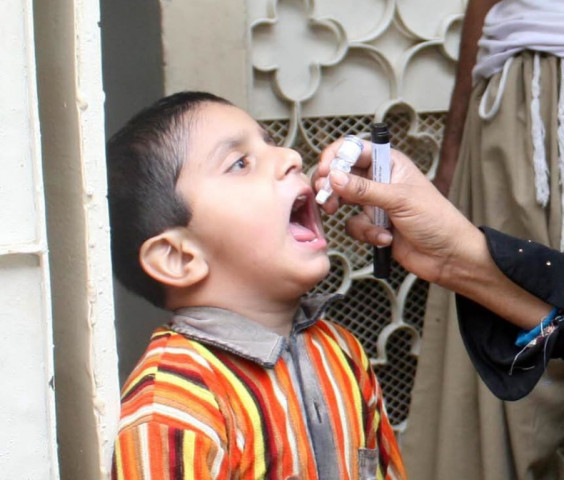 file photo of a woman giving polio drops to a child photo mohammad saqib file photo of a woman giving polio drops to a child photo mohammad saqib