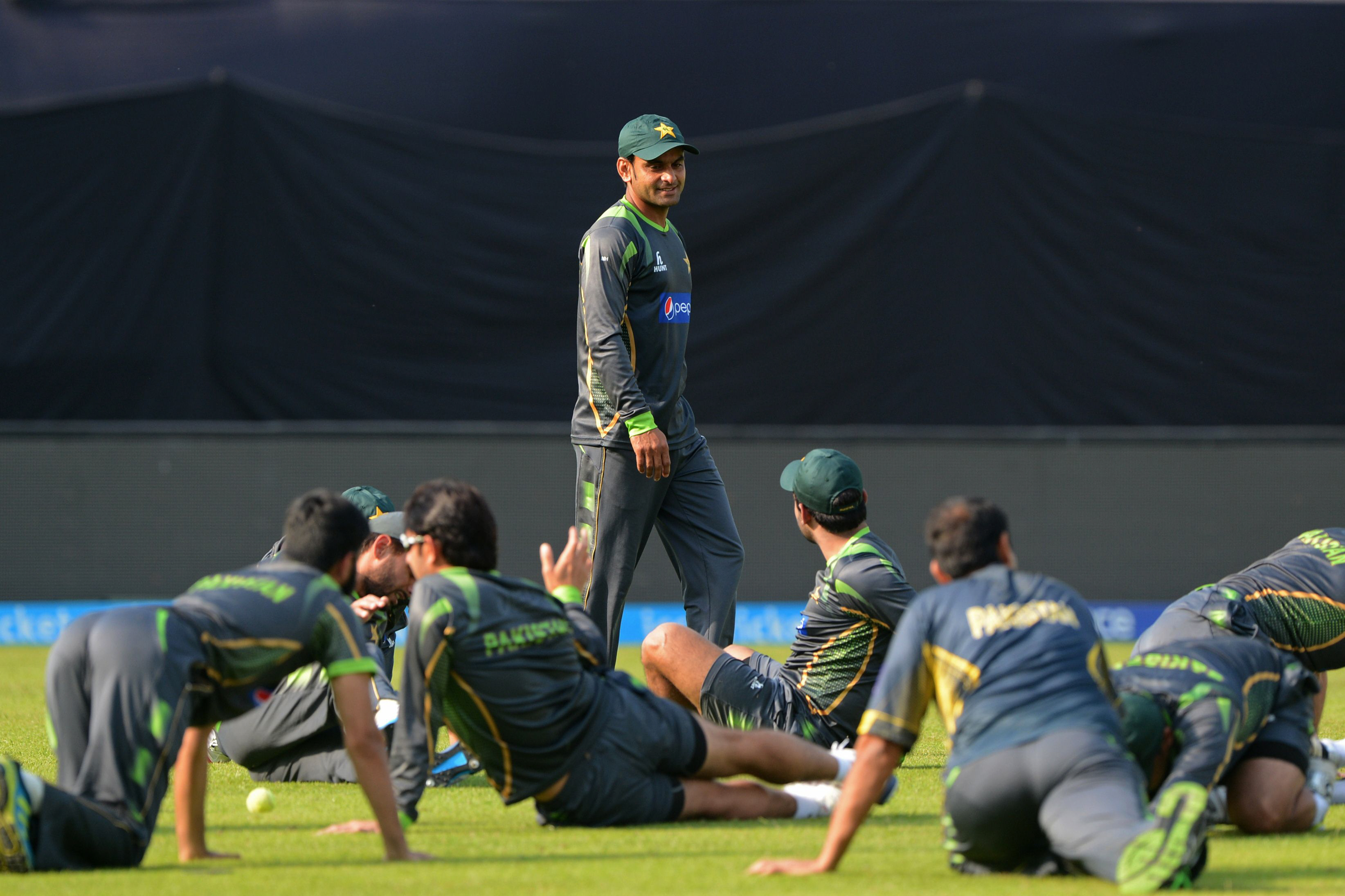 hafeez looks on as other cricketers stretch at a training session during the icc world twenty20 cricket tournament at the sher e bangla national cricket stadium in dhaka on march 20 photo afp