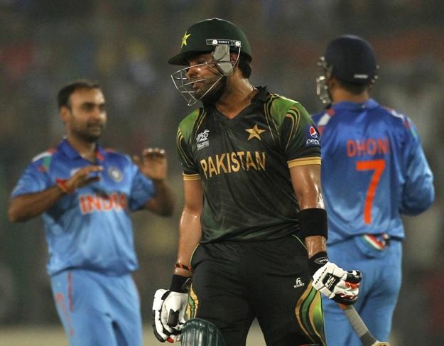 pakistan 039 s umar akmal reacts after teammate shoaib malik is dismissed as india 039 s captain and wicketkeeper m s dhoni r and bowler amit mishra l celebrate during their icc twenty20 world cup cricket match at the sher e bangla national cricket stadium in dhaka march 21 2014 photo reuters