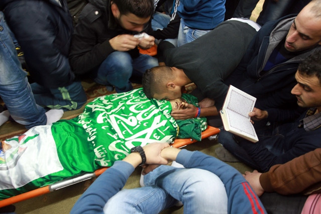 a palestinian man kisses the body of hamza abu al heja 20 a member of the ezzedine al qassam brigades the military wing of the palestinian hamas movement photo afp a palestinian man kisses the body of hamza abu al heja 20 a member of the ezzedine al qassam brigades the military wing of the palestinian hamas movement photo afp