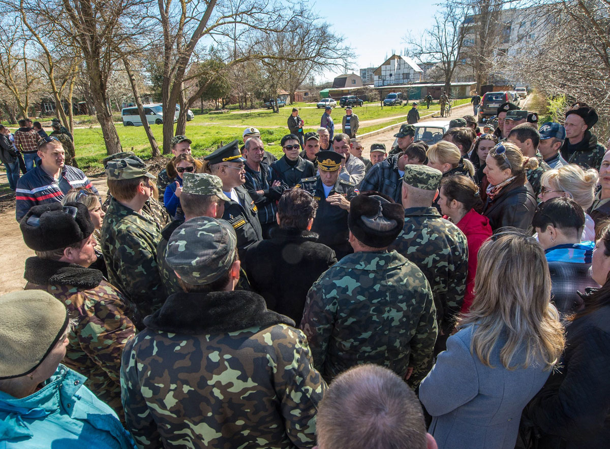 major general of the naval aviation of the russian black sea fleet igor kozhyn c speaks to ukrainian pilots and their wives at the fedorovka airbase in the saki district of crimea on march 22 2014 photo afp