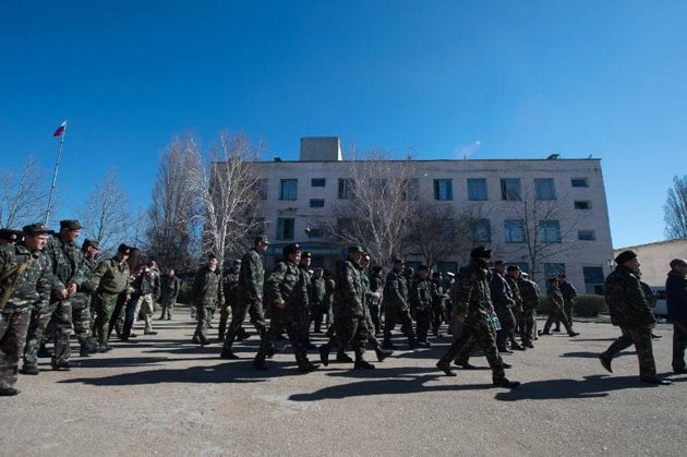 ukrainian soldiers walk out of an air force base in the small city of novofedorivka in the saki district of western crimea photo afp