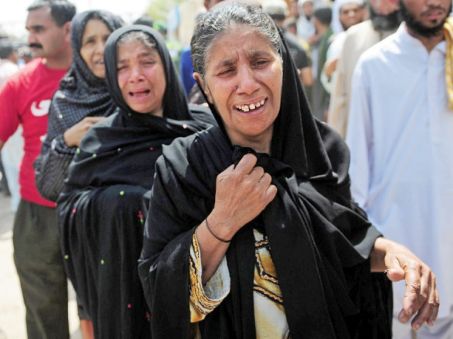 women mourn the death of relatives at a hospital in karachi photo afp women mourn the death of relatives at a hospital in karachi photo afp