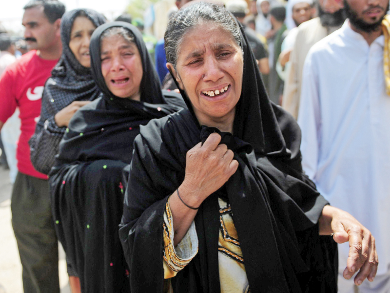 women mourn the death of relatives at a hospital in karachi photo afp