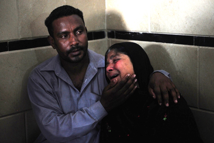 people mourn the death of relatives at a hospital in karachi on march 22 2014 following a transportation accident in hub photo afp