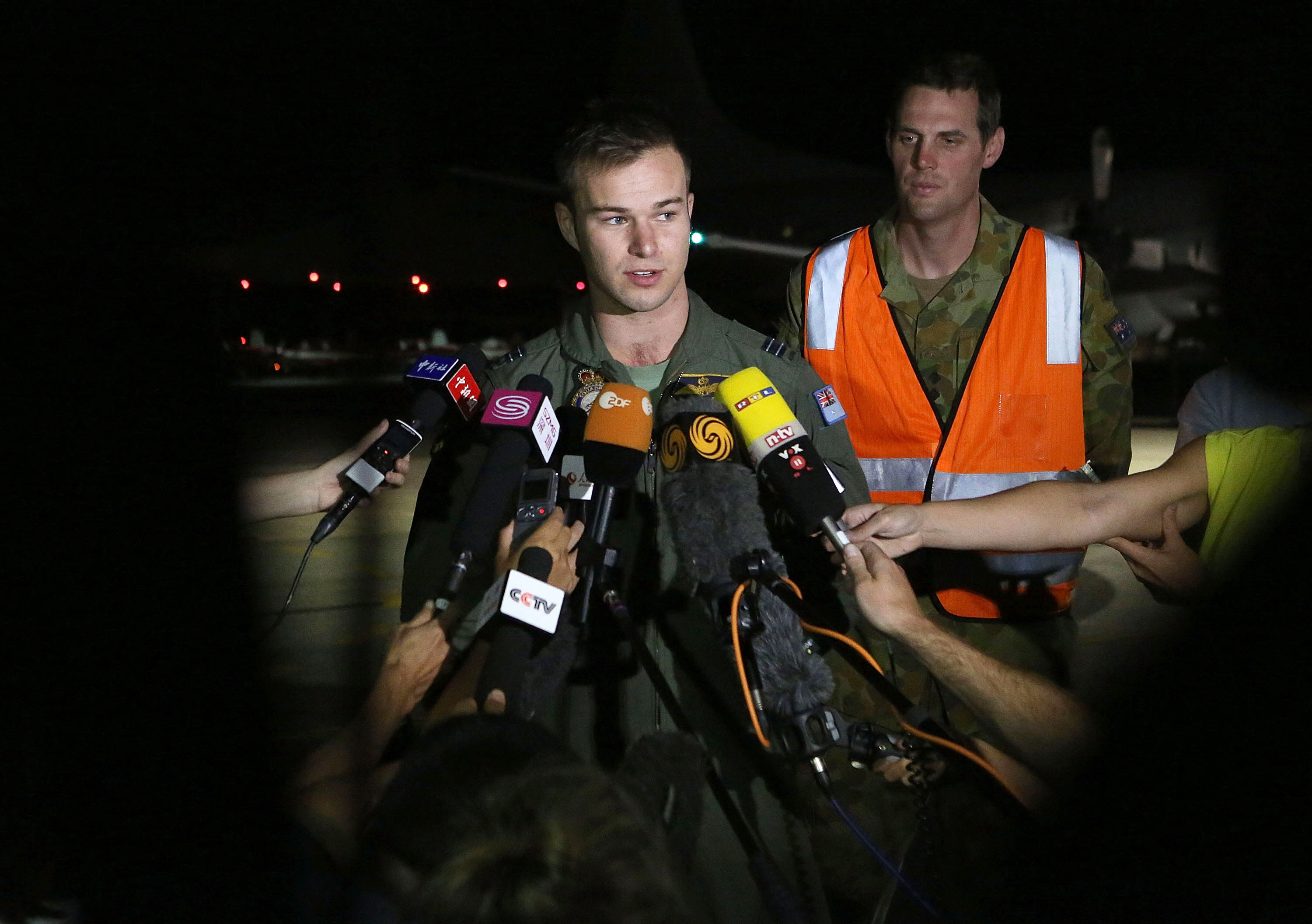 royal australian air force flight lieutenant russell adams l speaks to the media after returning from a search mission the sighting of a wooden pallet and other debris that may be linked to the malaysian passenger jet raised hopes a breakthrough in the international search for the missing plane photo afp