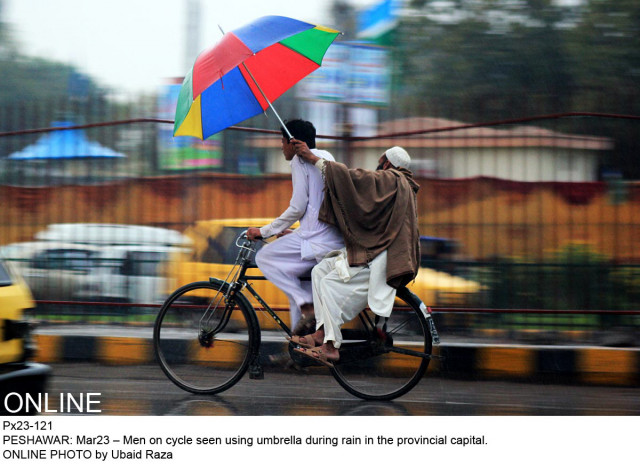 two men seen using an umbrella during rain in the provincial capital on march 23 photo online two men seen using an umbrella during rain in the provincial capital on march 23 photo online