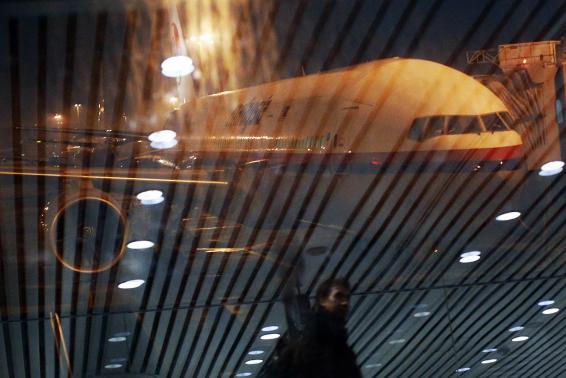 malaysia airlines boeing 777 200er flight mh318 to beijing sits on the tarmac as passengers are reflected on the glass at the boarding gate at kuala lumpur international airport photo reuters