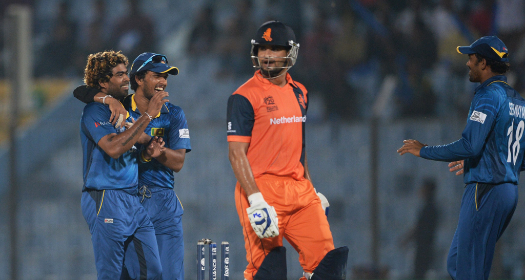 sri lanka cricket captain dinesh chandimal 2l celebrates after netherlands batsman mudassar bukhari was clean bowled by lasith malinga l during the icc world twenty20 tournament cricket match between netherlands and sri lanka at the zahur ahmed chowdhury stadium in chittagong on march 24 2014 photo afp