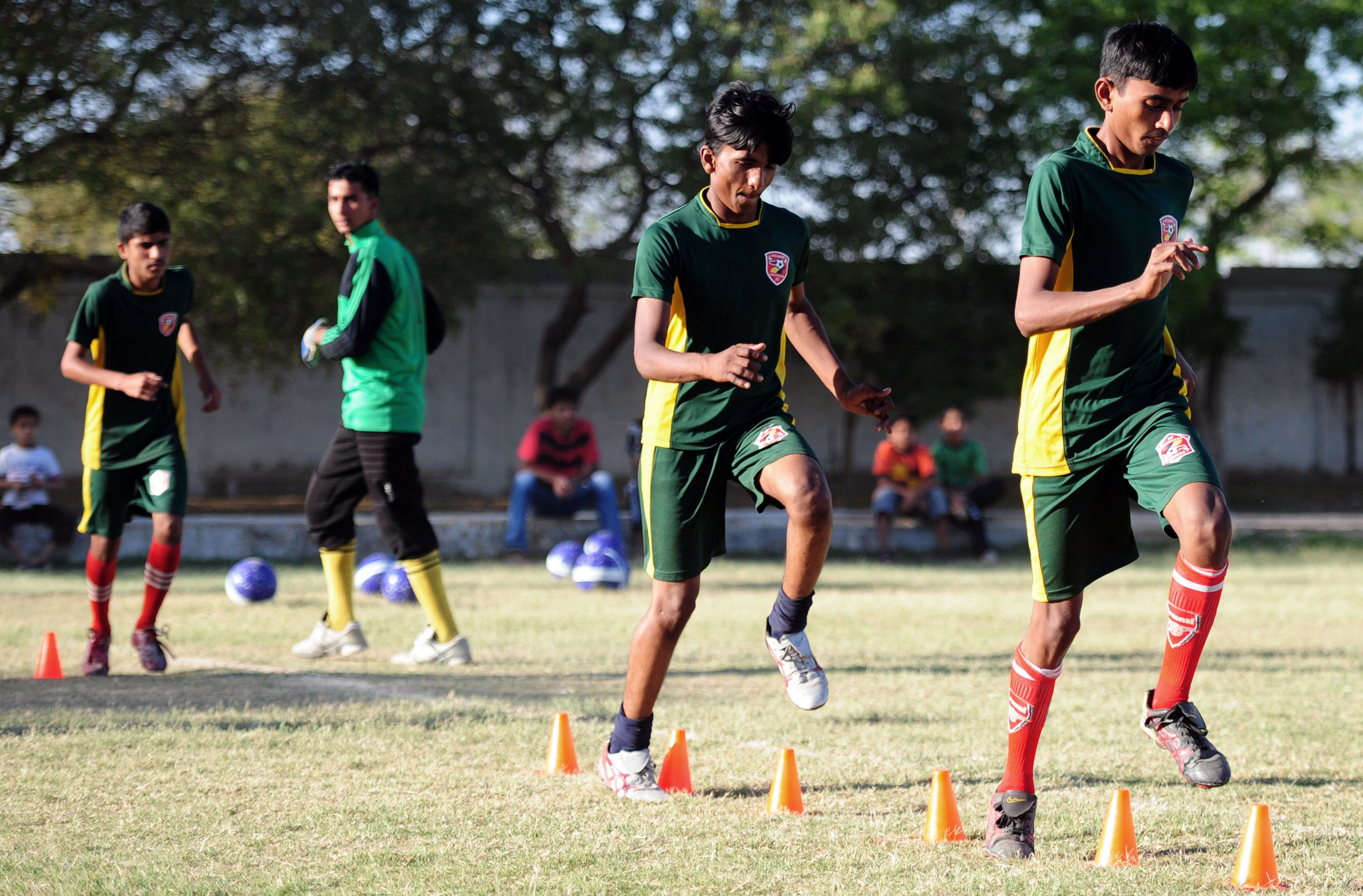 mohammad salman second right running with other street children during football training camp in karachi for the forthcoming street child world cup in brazil photo afp