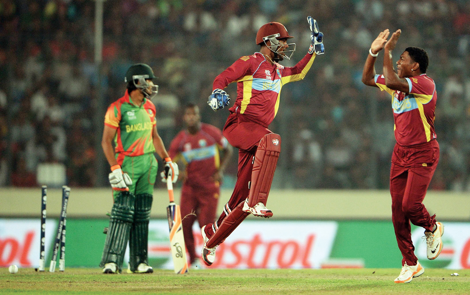 the defending champions west indies crushed hosts bangladesh in an impressive all round performance to keep their hopes alive in the world twenty20 photo afp