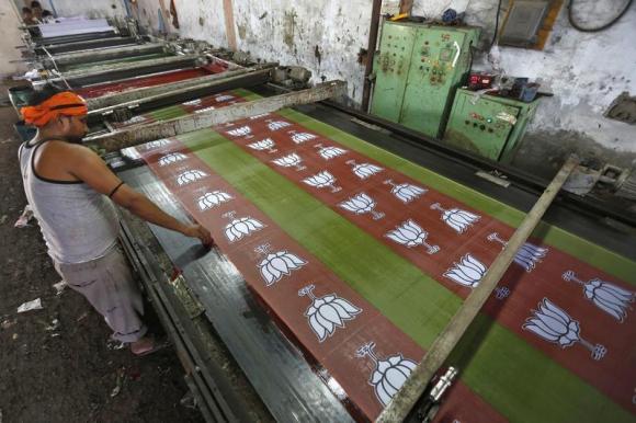 a worker prints the flags of india 039 s main opposition bharatiya janata party bjp in a factory photo reuters