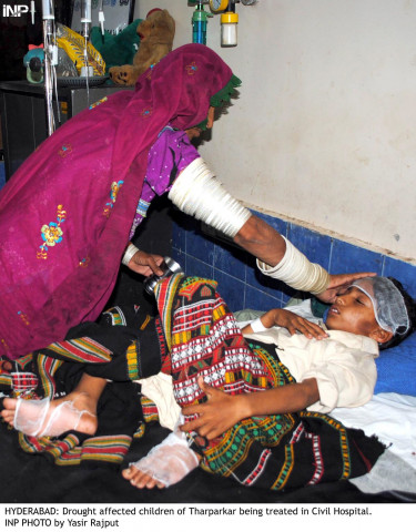 a woman from thar tends to her sick child at the civil hospital in hyderabad photo inp a woman from thar tends to her sick child at the civil hospital in hyderabad photo inp